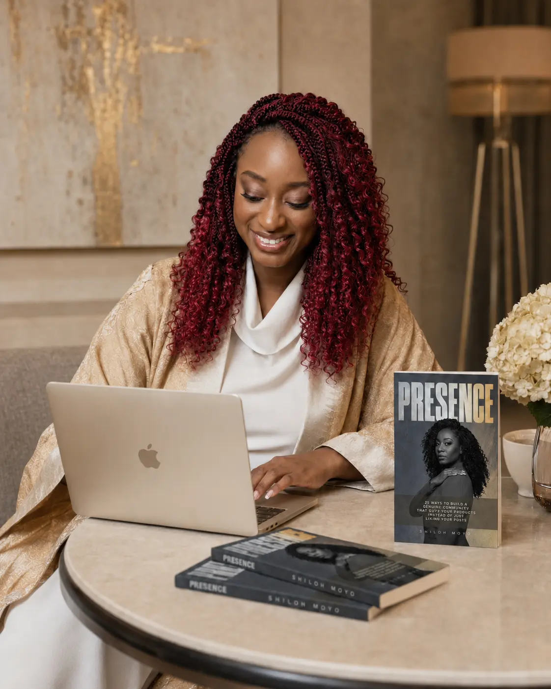 Shiloh working beside copies of Presence